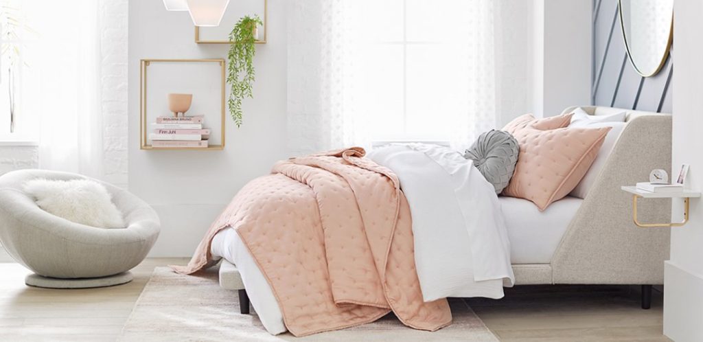 Light colored aesthetic room from PBTeen with light oatmeal upholstered bed and light gray round chair