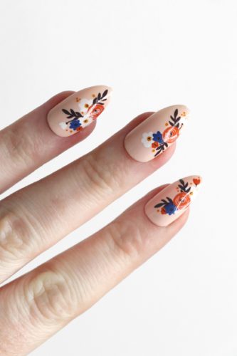 Modern floral nails in peach beige with blue and orange flower detailing - nail art, nail artist flower nail design matte finish