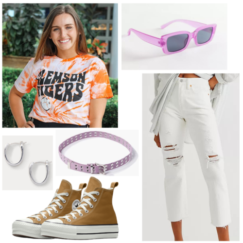 College game day outfit with tie dye team t-shirt, white ripped jeans, high top brown Converse, purple sunglasses and belt, silver earrings