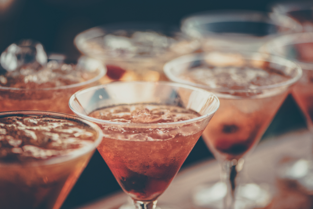 Photo of a row of cocktails in martini glasses