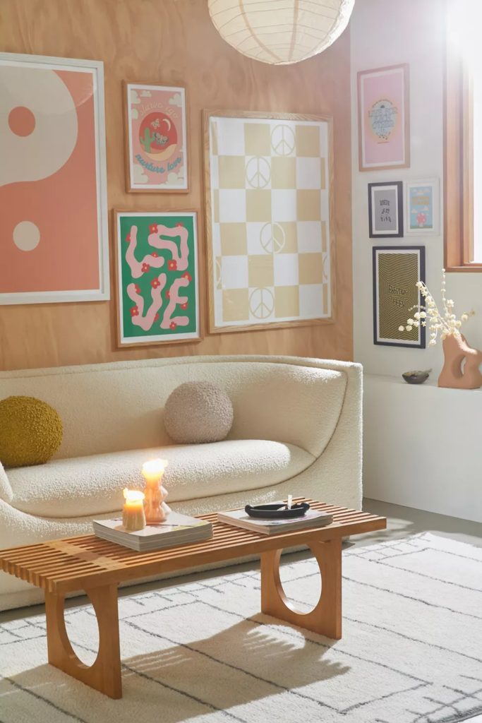 Light colored boucle couch, white sideboard, and wood coffee table in a room